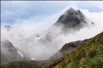 Clouds hanging on the peak. Mountain landscape at Cooper Bay, South Georgia Island.